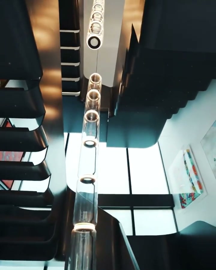 The floating stair, lit by a cascade of ring pendants